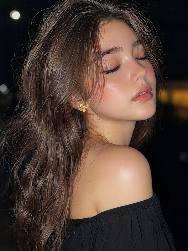 Closed-eye beauty portrait in a black off-shoulder garment